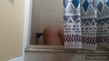 Play Femboy rides his big rainbow dildo in shower